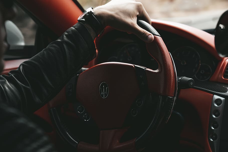 man driving Maserati car, human, person, steering wheel, driver