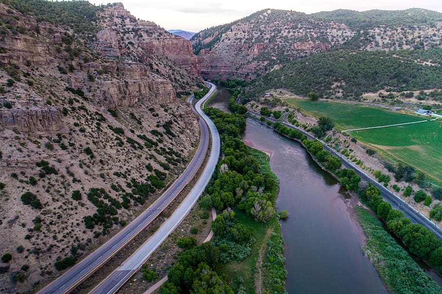 winding road near brown rocky mountain at daytime, river, canyon HD wallpaper