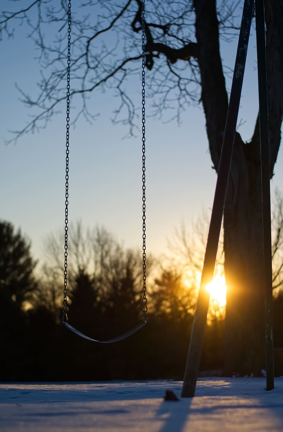 empty swing during golden hour, flare, light, sunlight, outdoors