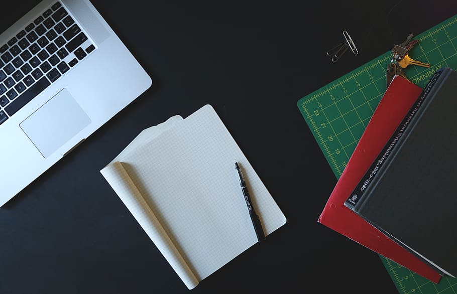 White Printer Paper Beside Macbook Pro on Black Surface, desk HD wallpaper