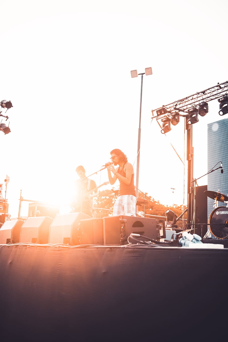 man singing on stage, singer, person, microphone, light, sunset HD wallpaper