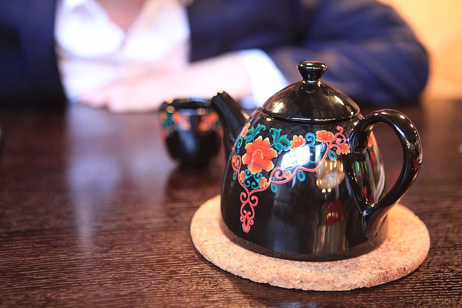 teapot, hand, close-up, table, focus on foreground, indoors HD wallpaper