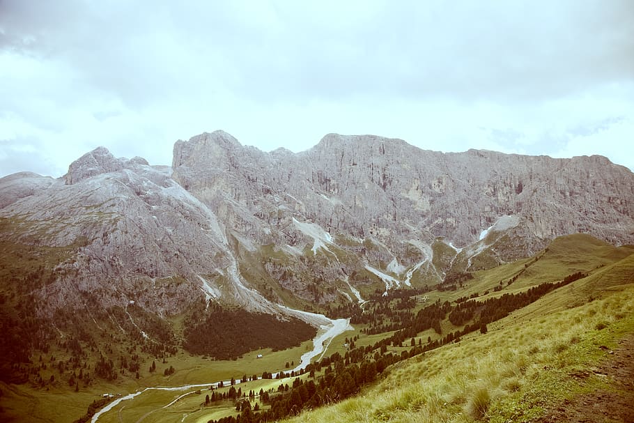 Grey Formation of Rock Mountain by the Green Field during Daytime HD wallpaper