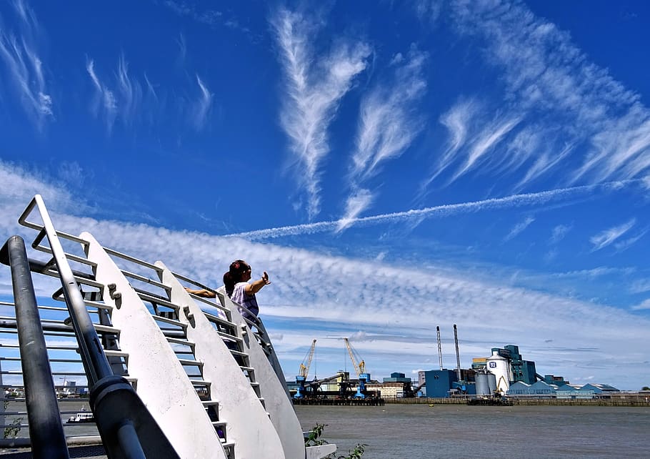 Woman Standing on Front of Gray Barriers, bay, boat, clouds, daylight HD wallpaper
