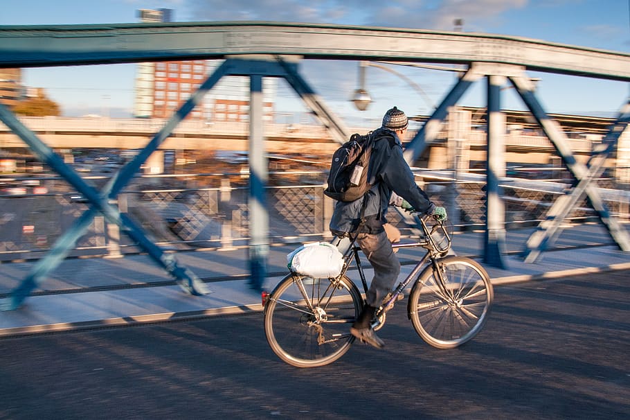 Man in Black Jacket Riding Black Bicycle in Gray Concrete Road in Panning Photography HD wallpaper