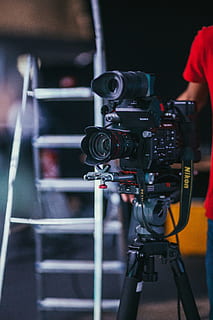 black professional camera with tripod, ladder, camera strap, person HD wallpaper