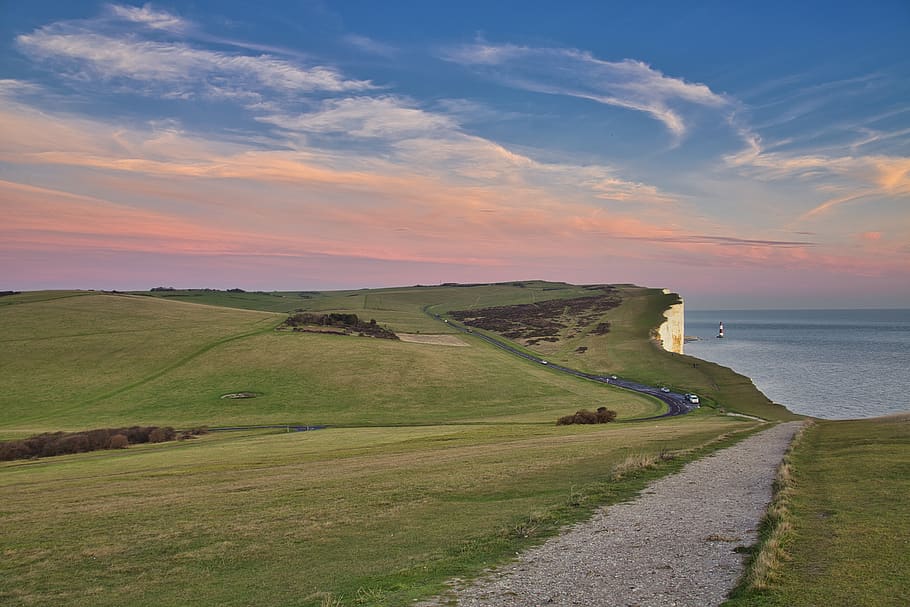 Green Grass Field Beside Body of Water, cliff coast, clouds, cropland HD wallpaper