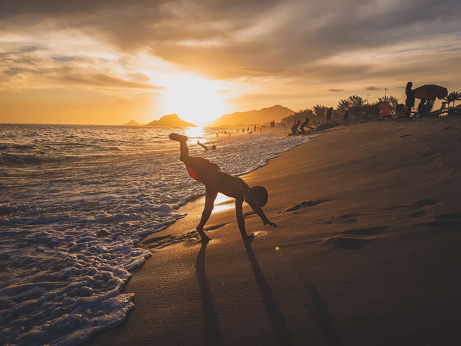 Boy Playing Near Shore, backlit, beach, beautiful, coast, dawn HD wallpaper