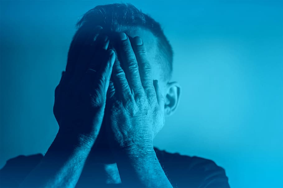 Depression - Sadness - Despair - Man with Hands Covering Face - Blue Tone