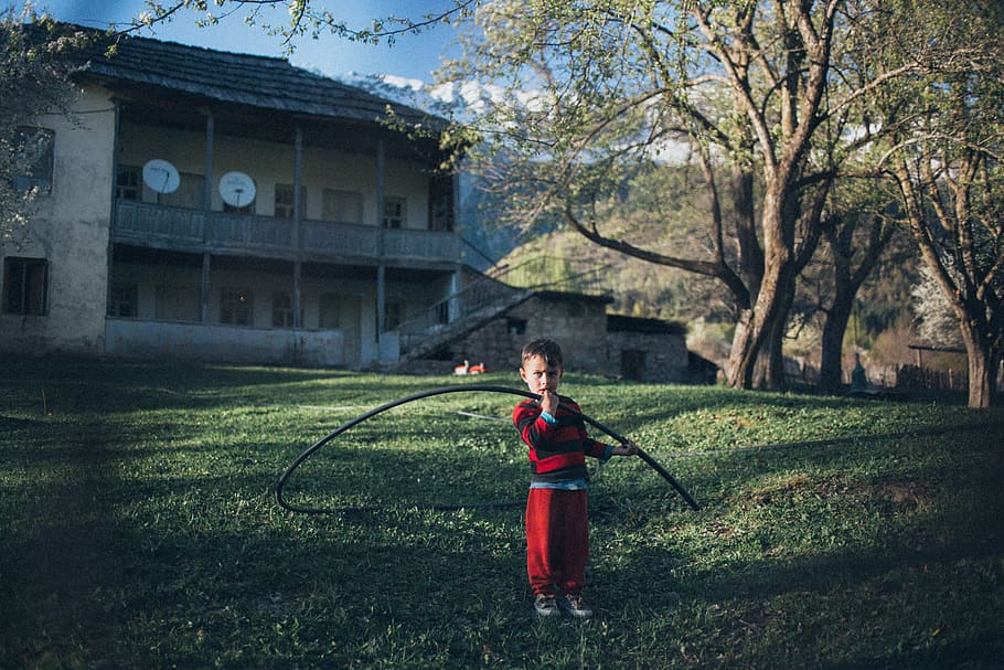 Boy Wearing Red and Black Shirt Holding Black Hose, building HD wallpaper