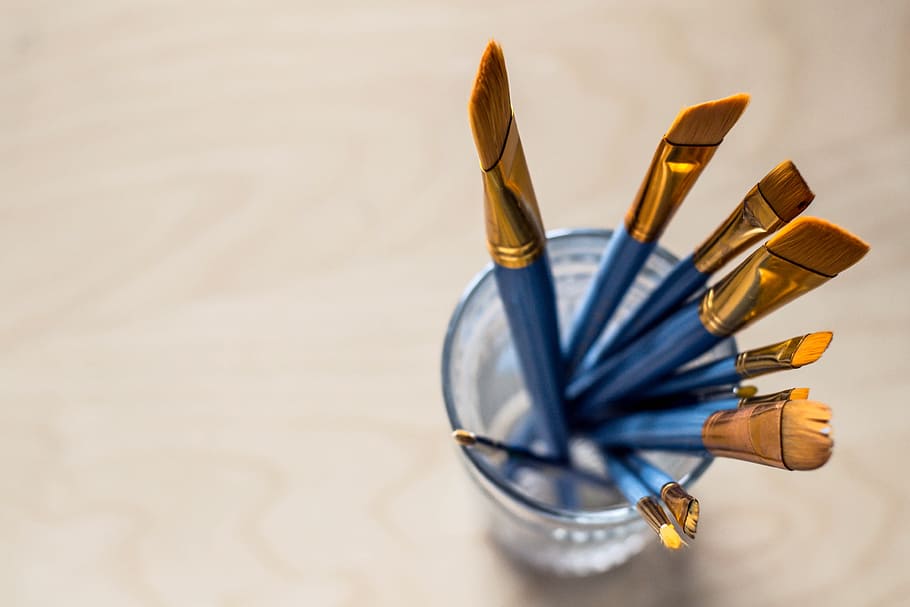 Paint Brushes Placed in a Glass Jar Placed on the Home Office Desk HD wallpaper
