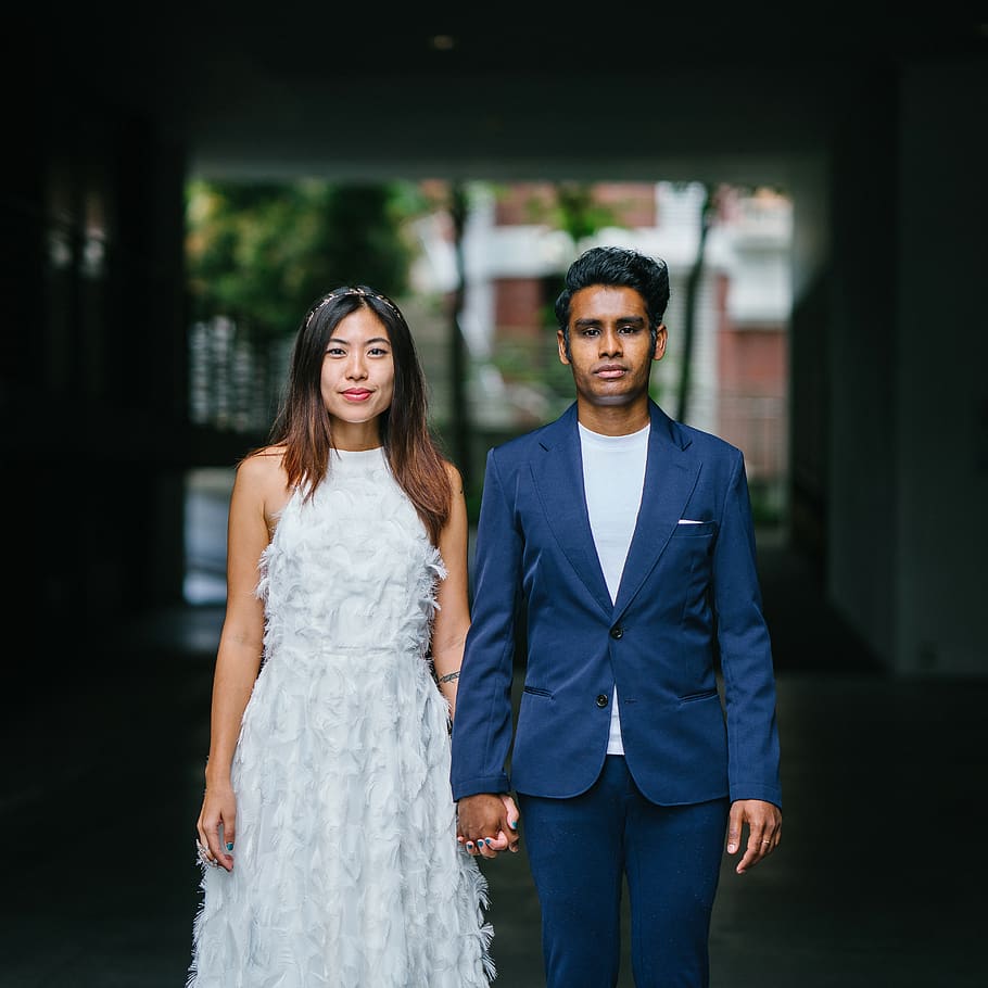 Woman in White Sleeveless Dress and Man on Blue Blazer, asia