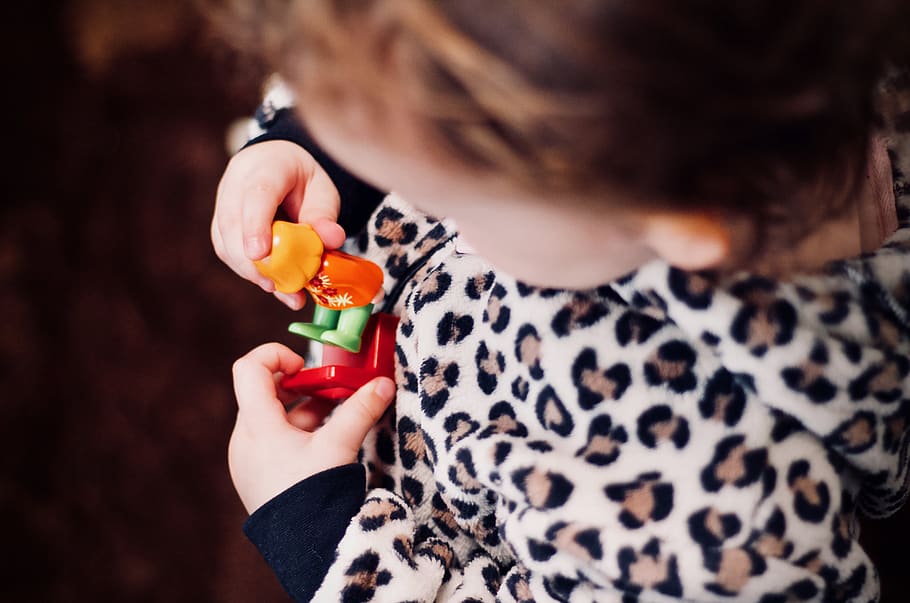 girl holding plastic toys in macro photography, human, person
