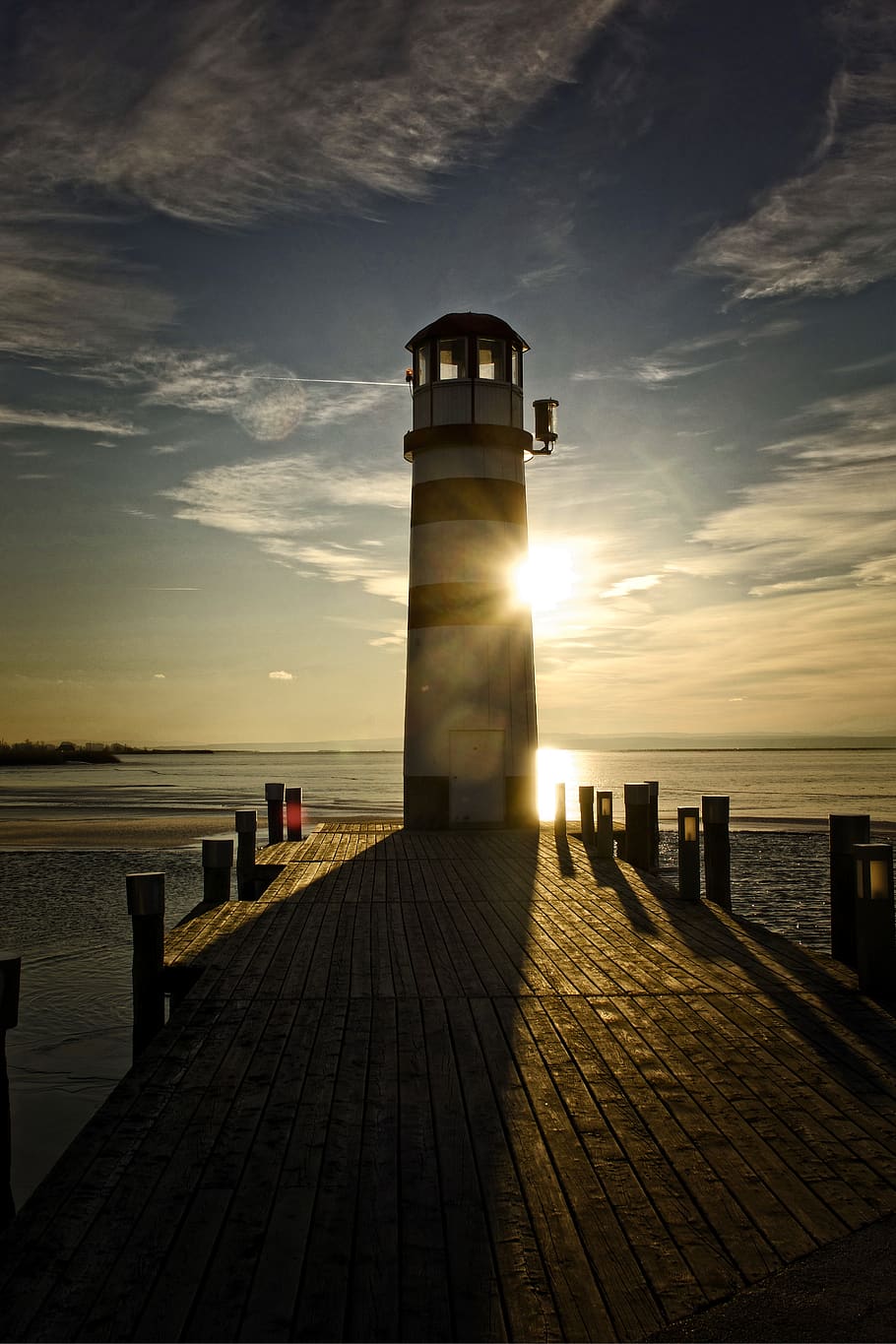 lighthouse, winter, sunset, lake, water, nature, ice, sky, direction HD wallpaper