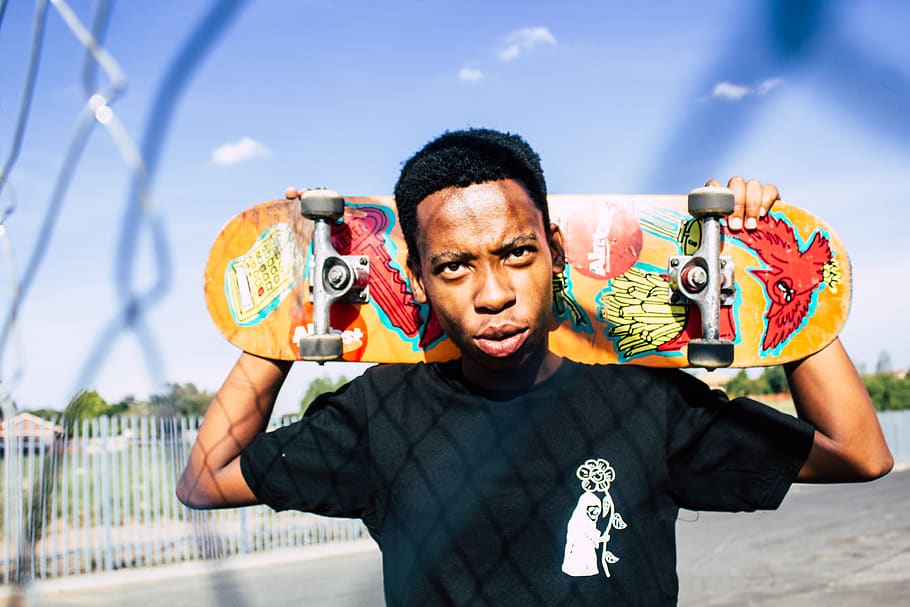 man carrying skateboard, one person, men, front view, portrait HD wallpaper