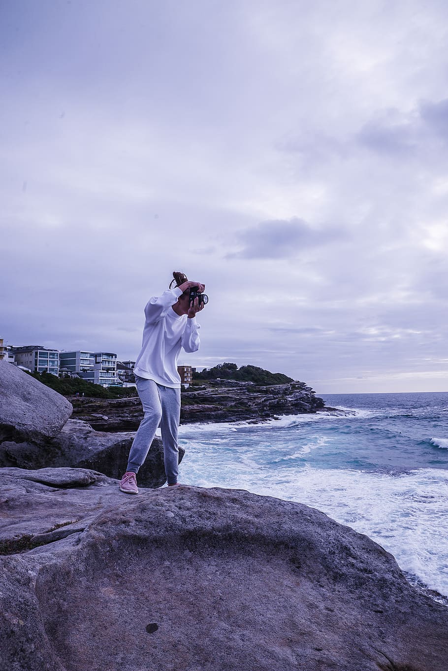 Man Taking Photo of Sea While Standing on Rock, beach, camera HD wallpaper