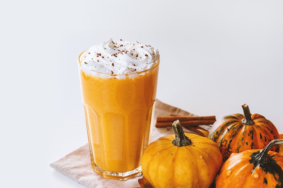 Pumpkin smoothie. Small pumpkins and drink on the white background HD wallpaper