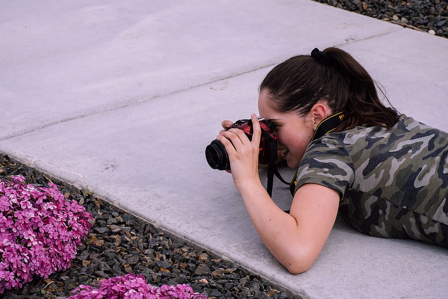 Woman Lying on Pavement While Taking Photo, camera, flowers, girl HD wallpaper