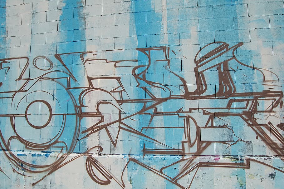 A basic graffiti drawing on a blue and white brick wall., wall street art in a public place, HD wallpaper