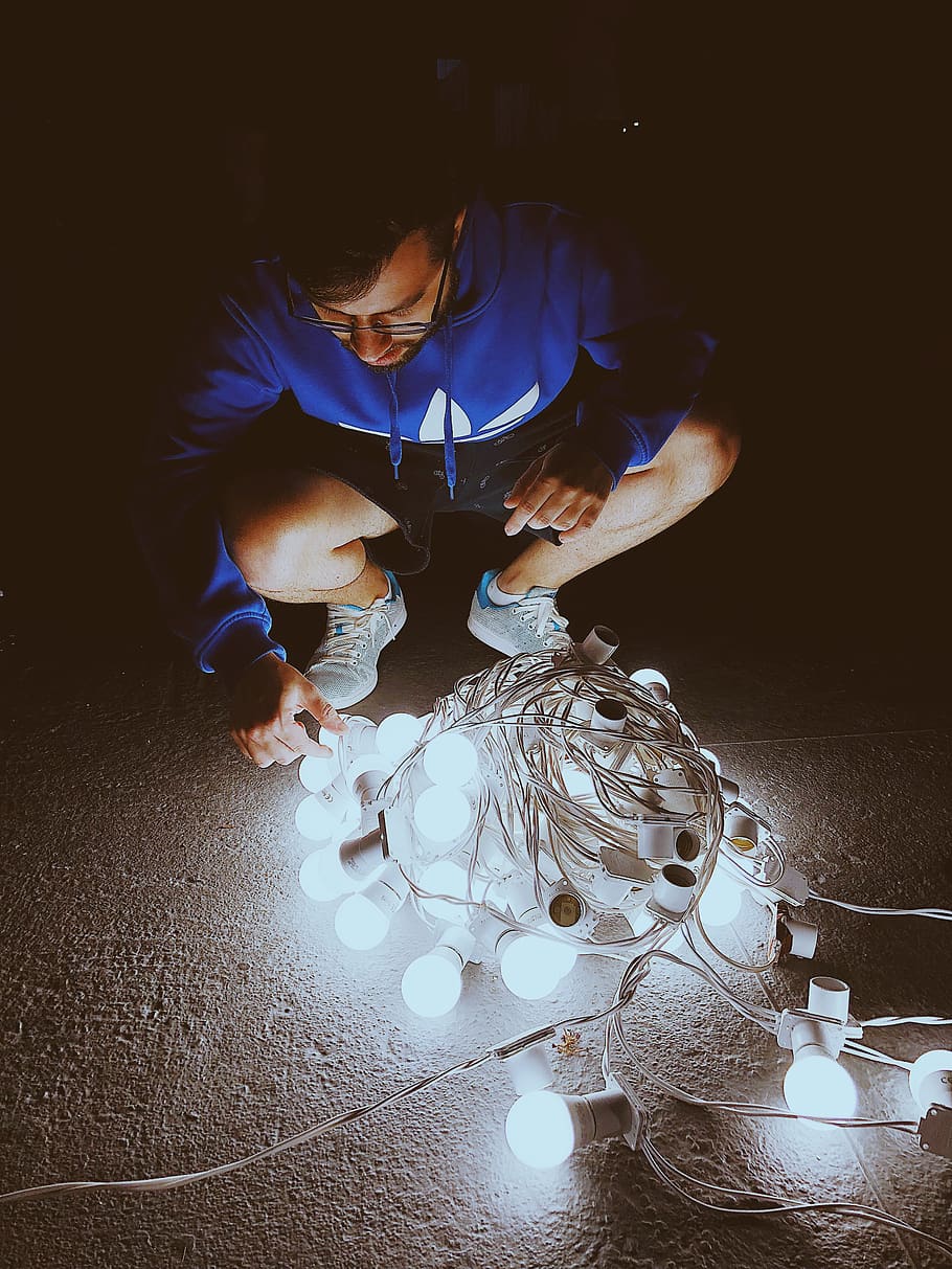 Man Fixing Light Bulb String, art, color, dark, electricity, energy HD wallpaper
