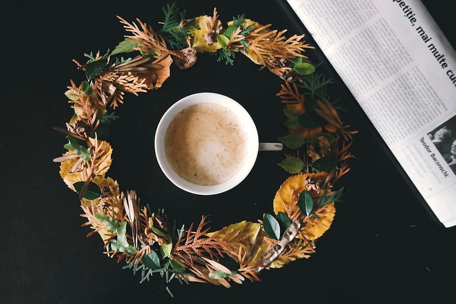 White Cup of Coffee in the Middle of Yellow and Green Flower Wreath HD wallpaper