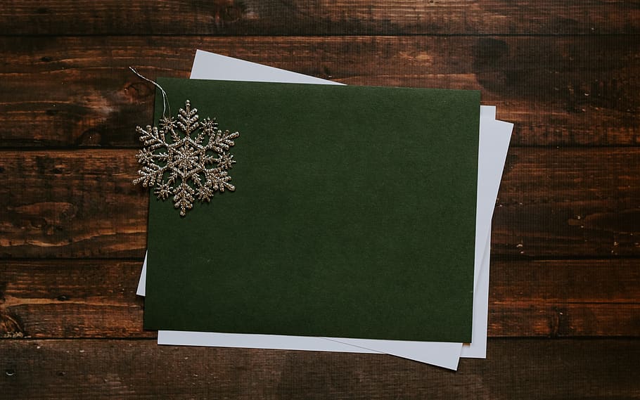 gray snowflake on green paper, wood - material, table, no people HD wallpaper