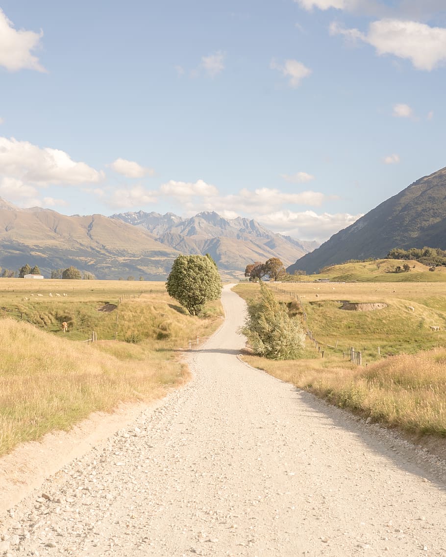 empty road in between grass field during daytime, gravel, dirt road HD wallpaper