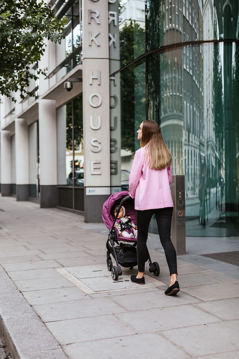 woman walking with child inside stroller, female, baby, building