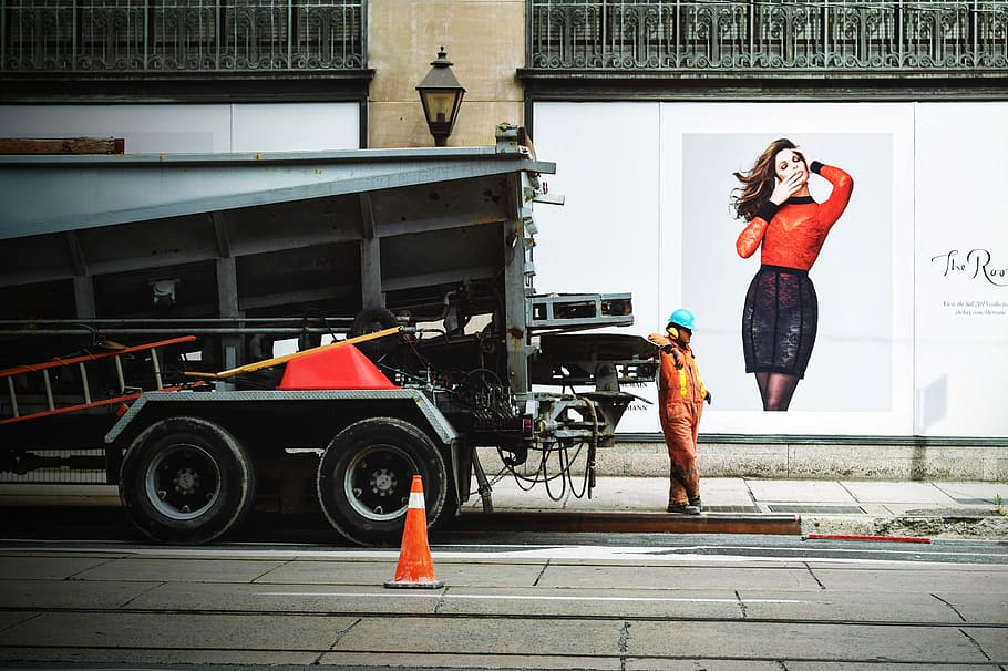 Man in Orange Safety Suit Standing Beside Truck Bed, city, construction HD wallpaper