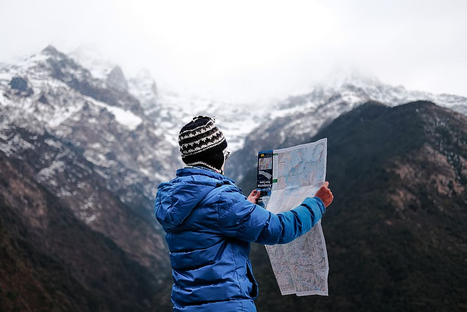 man holding map, clothing, apparel, nature, mountain, outdoors