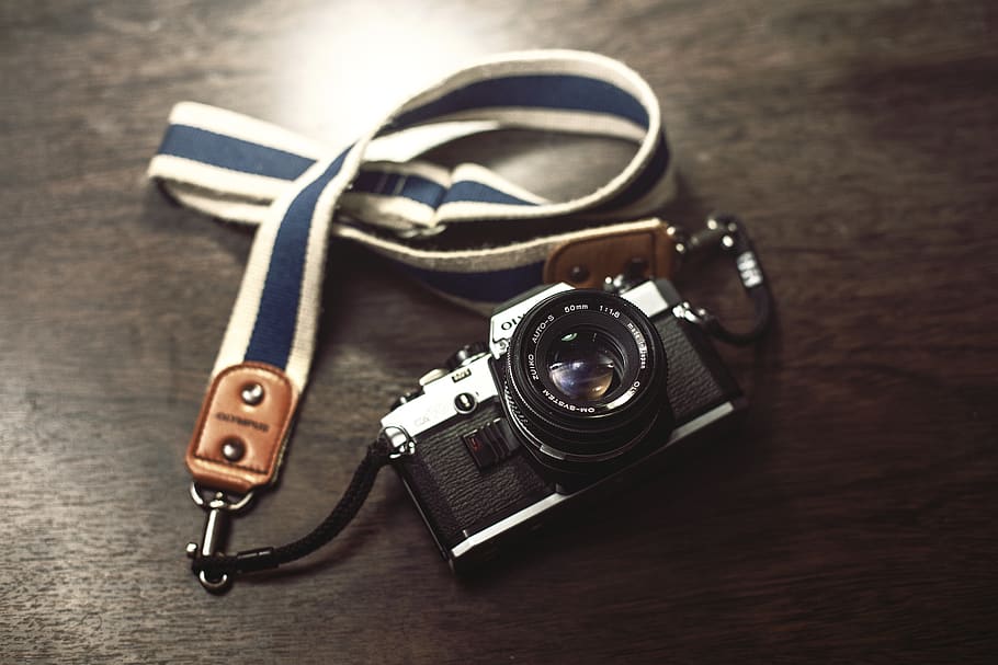 Black and Gray Bridge Camera With White and Blue Lanyard, analog camera