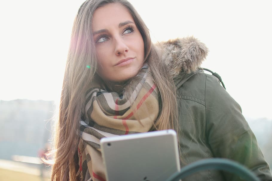 Nice girl looks around and has a tablet in hand, portrait, one person HD wallpaper
