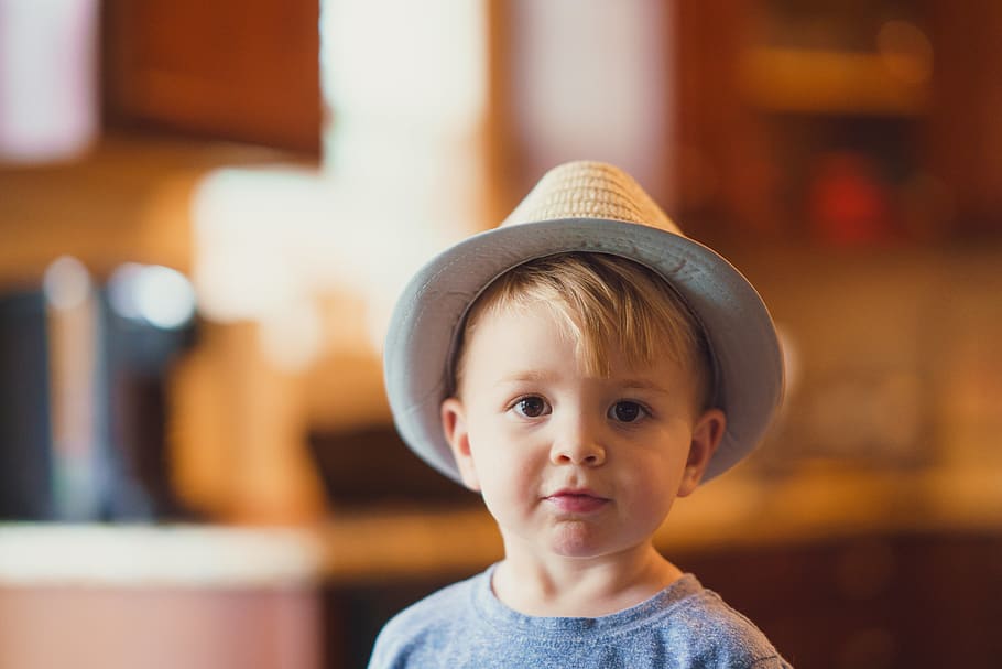 closeup photo of boy wearing brown fedora hat, human, person
