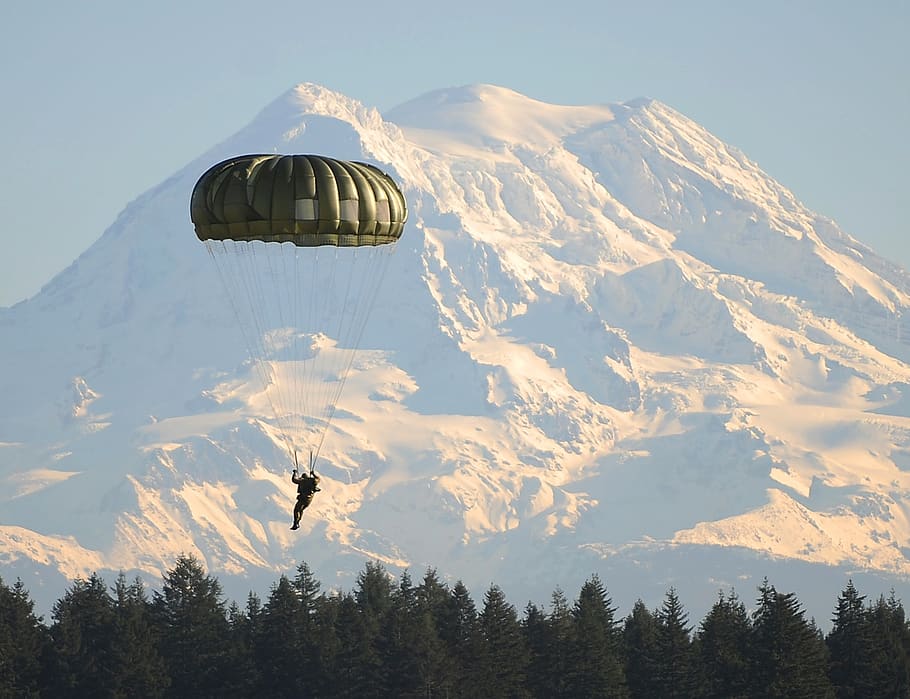 Man Flying on Parachute Near Green Trees, adventure, cold, landing HD wallpaper