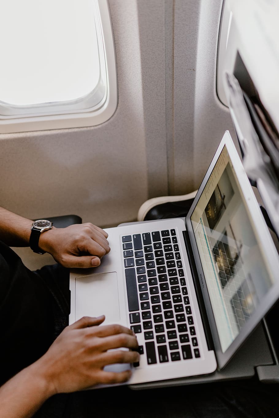 Unrecognizable man with notebook sitting inside an airplane, adult HD wallpaper