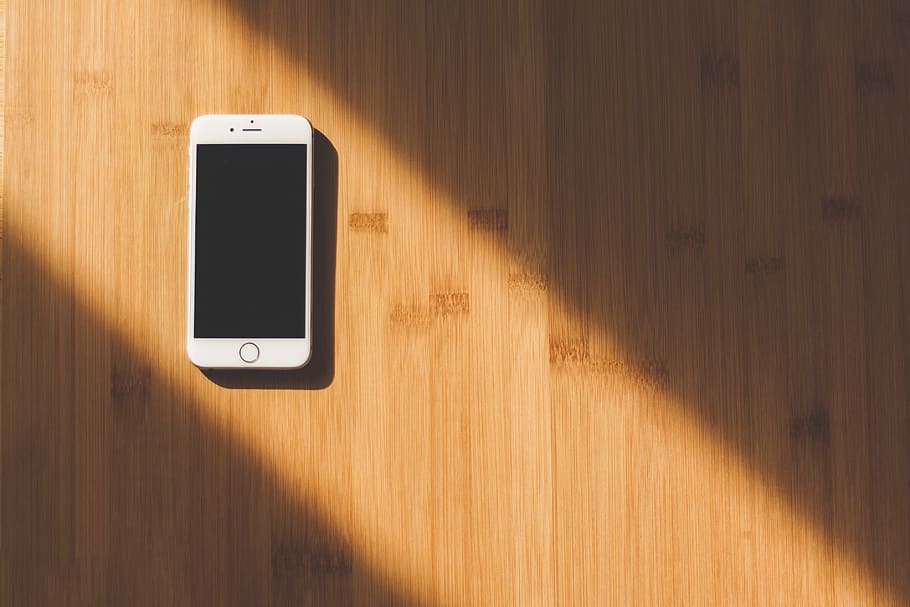 White Apple Iphone on Wooden Table, mobile, smartphone, sunlight HD wallpaper
