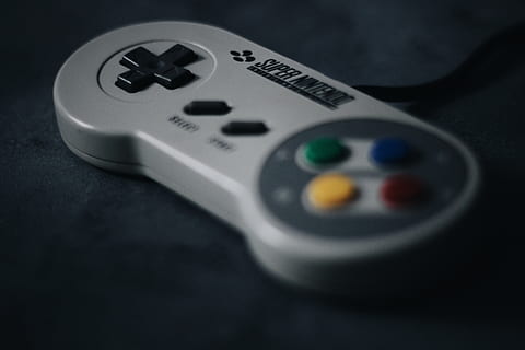 SNES controller on black surface, studio shot, no people, remote control HD wallpaper