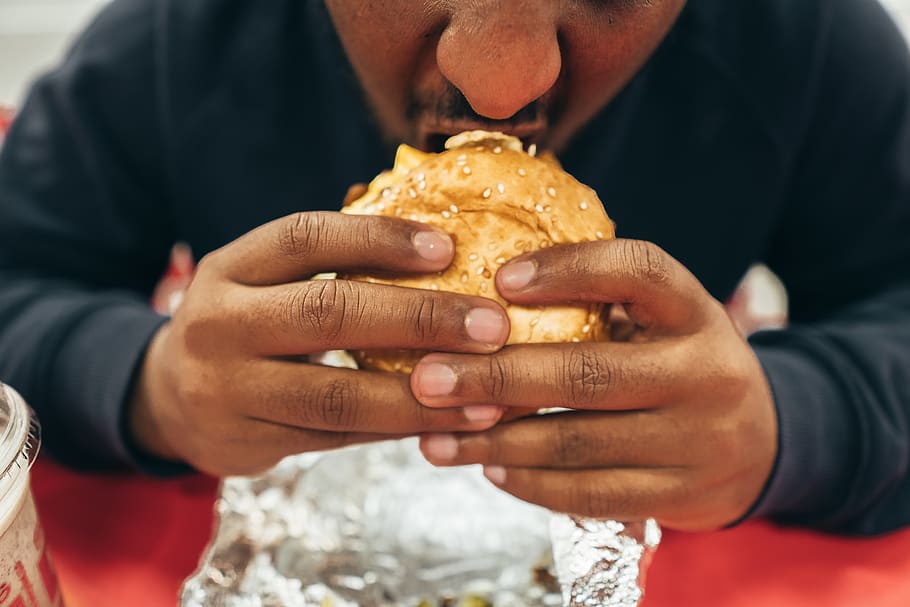man eating hamburger, food, holding, one person, food and drink HD wallpaper