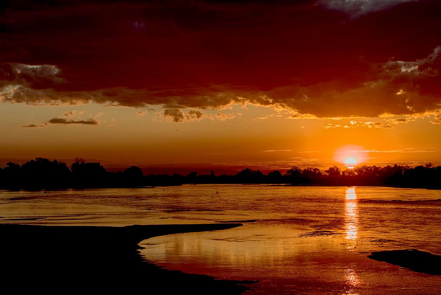silhouette of trees near body of water, sunset, sky, nature, zambia