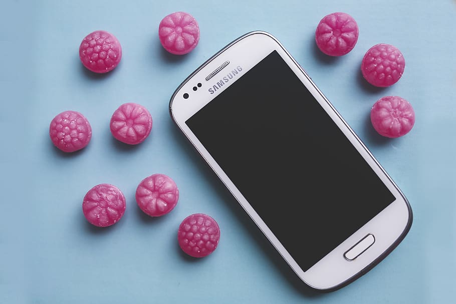 Pink candies and white smartphone, candy, sugar, smart phone HD wallpaper