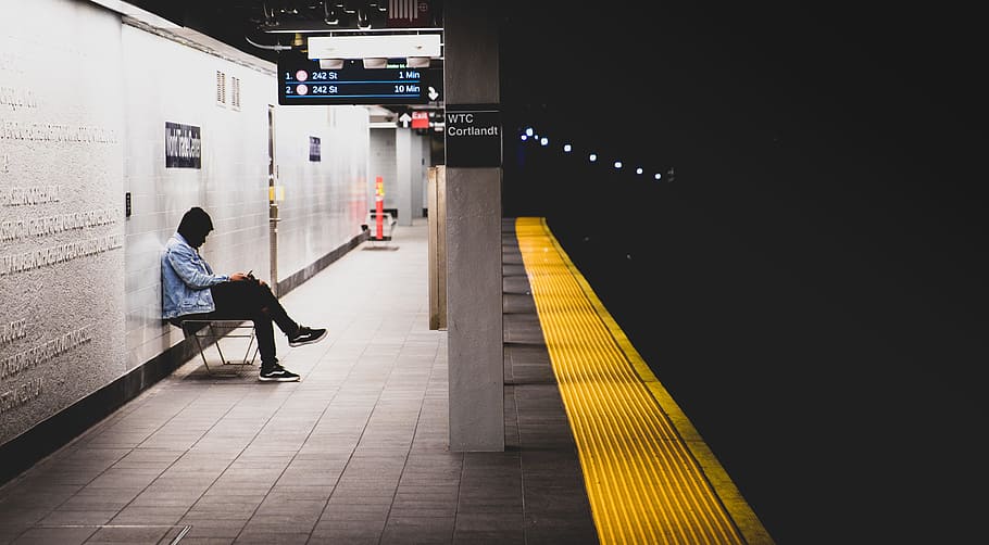 man sitting on a bench in a train station, subway, platform, underground HD wallpaper