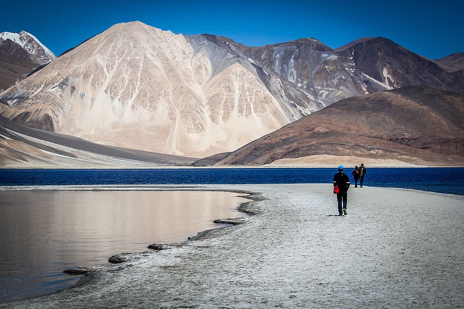 Man Walking on Shore Near Mountain, clouds, cold, daylight, high HD wallpaper
