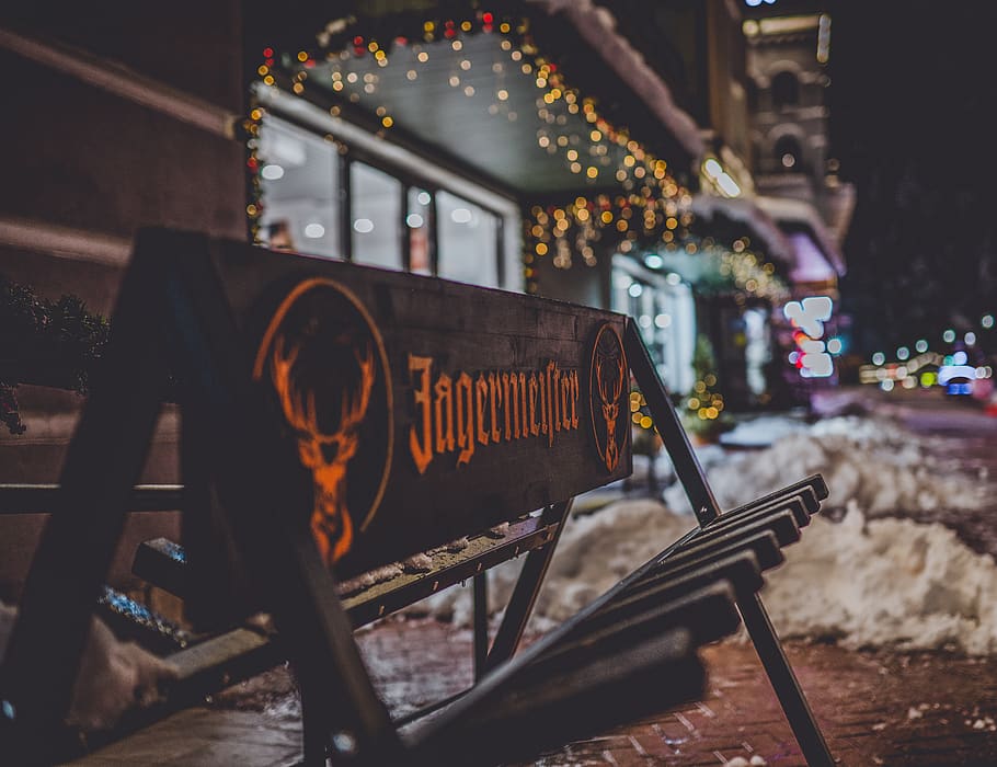 selective focus photo of brown and black wooden Jagermeister signage