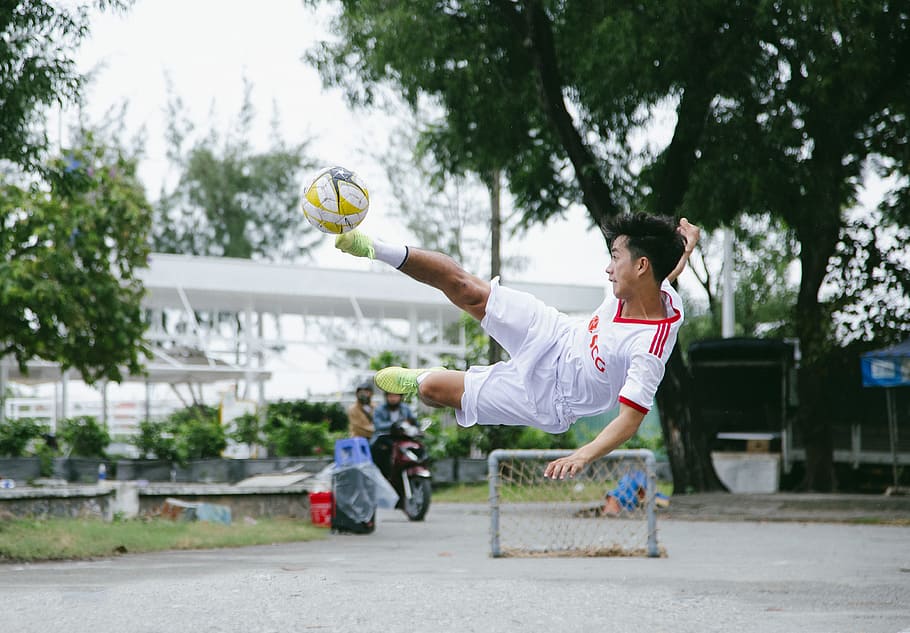 Time Lapse Photography of Soccer Player Jumping Kicking Ball HD wallpaper