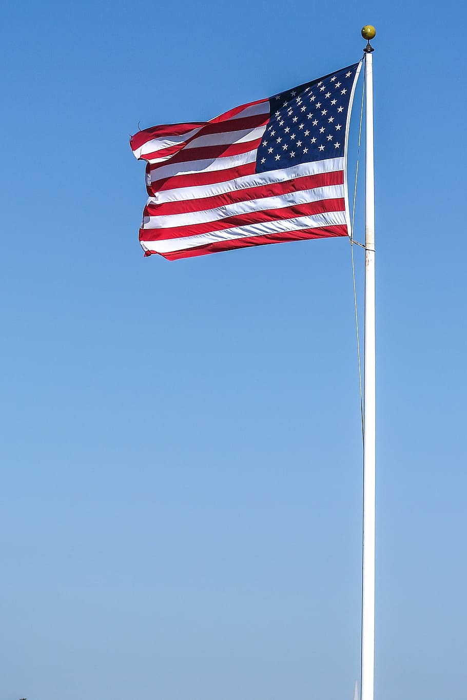 Stars and stripes at full staff, waving in the wind, america