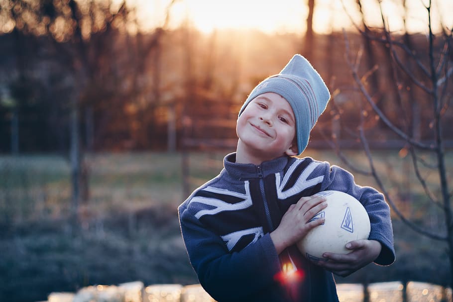 Selective Focus Photography of Boy Wearing Blue United Kingdom Print Zip-up Jacket Carrying White Ball, HD wallpaper