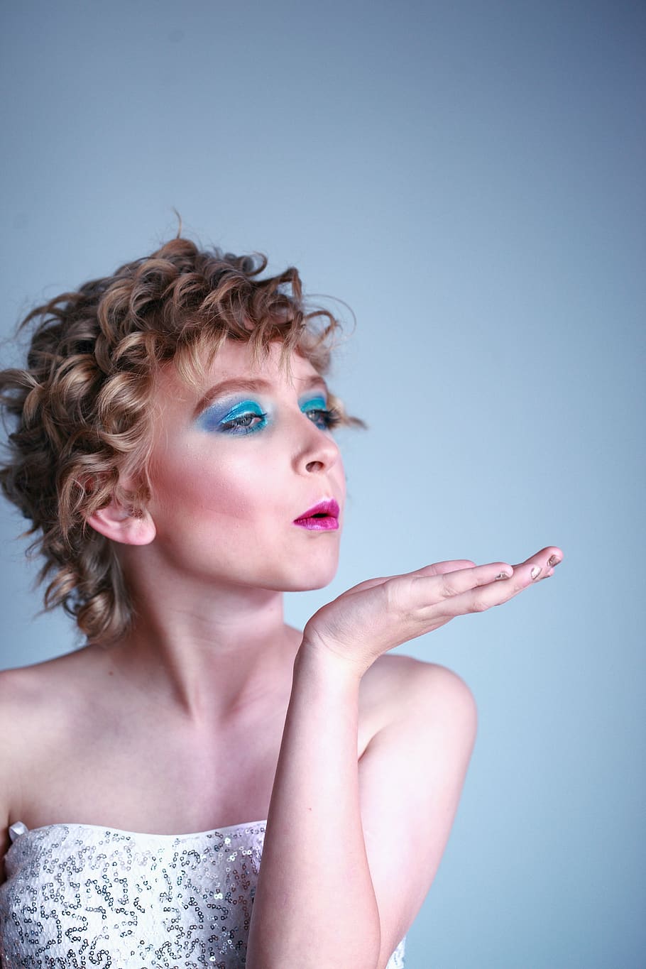woman blowing, young adult, studio shot, one person, blue, portrait HD wallpaper