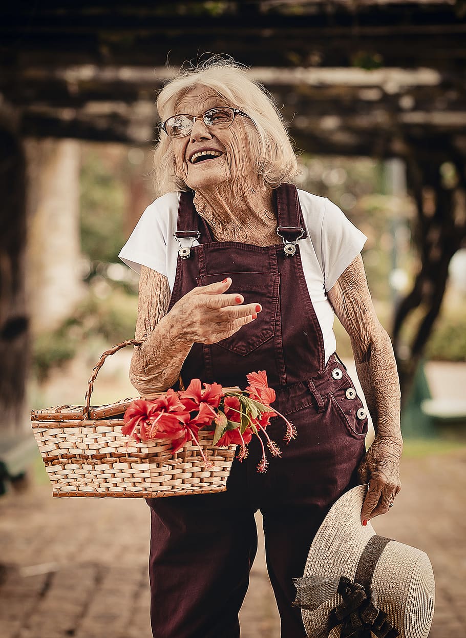 Woman Wearing Brown Dungaree Pants Holding Sunhat and Picnic Basket HD wallpaper