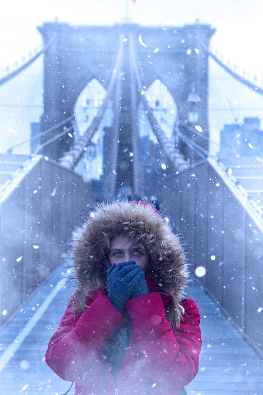 Woman Wearing Red Parka Jacket While Standing on Brooklyn Bridge HD wallpaper