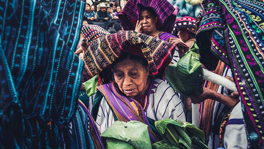 women holding green leaves, guatemala, unique, thoughtful, colorful